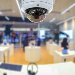 a security camera in a store with people in the background.