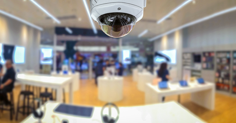 a security camera in a store with people in the background.